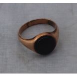 A yellow metal signet ring, set oval sard, (yellow metal assessed as 14ct. rose gold). (gross weight