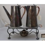 An early 20th century Asprey & Co silver plated coffee and hot water pot set on spirit burner stand,