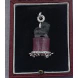 A platinum, carved bi-coloured tourmaline and diamond pendant, carved form a single tourmaline and