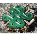 A Chinese "Endless knot" yellow metal, jade and diamond pendant/brooch, having pierced and carved