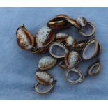 A yellow metal mounted graduated cowrie shell necklace, the links formed from the upper part of