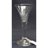 An 18th century wine glass, circa 1745, the trumpet bowl on plain stem with a single teardrop