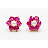 A pair of ruby and pearl earrings, flower cluster set with round cut rubies witha half pearl centre,
