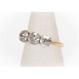 A diamond 18ct yellow gold three-stone ring, the three old-cut diamonds weighing a total of approx