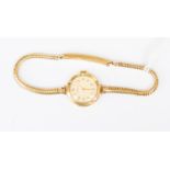 A 9ct gold Rotary ladies watch, round dial, case diameter approx 18mm, on a 9ct gold snake link