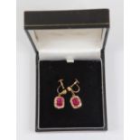 A pair of synthetic ruby and diamond cushion shaped drop cluster yellow gold earrings, the cushion