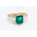 An emerald and diamond ring, set with an emerald cut emerald, weight approx 2.14 carat, tiered