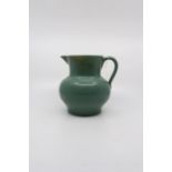 A Buchan Pottery jug.  Size 18cm. diameter including spout and handle.18cm. high. Condition; Small