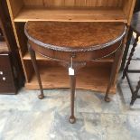 An early 20th Century semi circular walnut side table