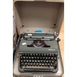 An Olympia Deluxe typewriter, cased