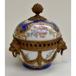 A French Sevres bowl and cover painted with a blue ground raised gilding and sprays of flowers, with