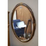 Late 20th Century oval mirror with gilt detail and early 20th Century oak wall mirror