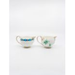 An English porcelain globe shaped Cream Jug with blue ribbons passing through gilt scrolls. Circa
