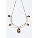 A Victorian garnet swag necklace, comprising five drops, the central drop with an oval cabochon