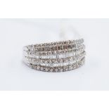 A seven row diamond set dress ring, comprising alternate rows of baguette cut and brilliant cut