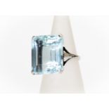 An aquamarine dress ring, step cut aquamarine measuring approx 17mmx 15mm, claw set in platinum,