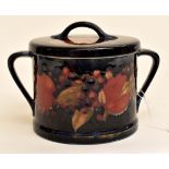 A Moorcroft blue glazed, hand signed, painted two handled biscuit barrel, complete with lid,