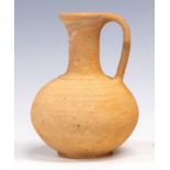 A Roman terracotta jug, bulbous body, loop handle, height 22cm