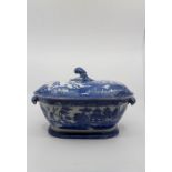 An early 19thcentury pearlware blue and white tureen, twin handled with the handle and finial