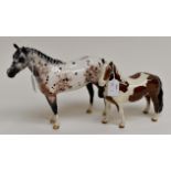 A Beswick apaloosa horse and a skewbald pony