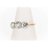 A diamond three-stone 18ct yellow gold ring, three round brilliant cut diamonds, total diamond