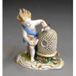 A Meissen figure of a putto with a bird cage and birds, 19th Century, blue crossed swords, incised