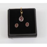 A 9ct gold, ruby and diamond cluster pendant, set with oval ruby with diamond border,  on a fine
