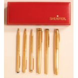 A collection of six gold plated Sheaffer pens/pencils including three fountain pens one with a 14k