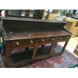 Early 18th Century three drawer oak dresser, brass handles, not original, with lower shelf and