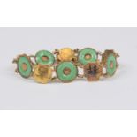 A Chinese and nephrite jade bracelet, round jade set to the centre with gold details, with alternate