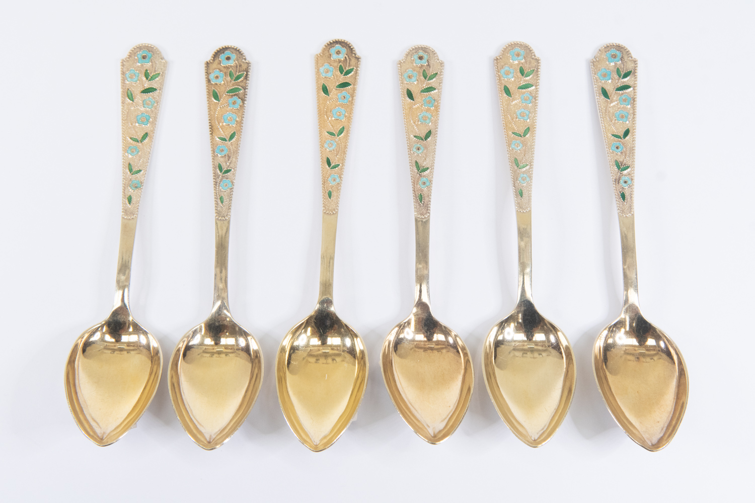 A set of six modern Russian silver gilt and floral enamel tea spoons