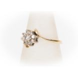 A 9ct gold and diamond set cluster ring, cross over design,  size L, total gross weight approx 1.