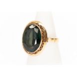 A gold and green stone ring, tests as 14k gold, the large oval stone, approx 13 mm x 17 mm, rub-over