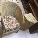 A Lloyd Loom chair along with a laundry basket