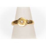 An 18ct gold and diamond set gents ring, round detail set to the centre with a star set diamond,