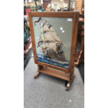 Wooden fire screen with wool work detailing a ship at sea.
