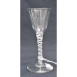 An 18th century opaque twist wine glass, the round funnel bowl on a multi strand helix and central