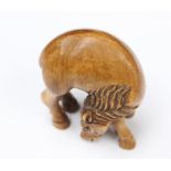 A Japanese carved figure depicting a pony, carved, feeding