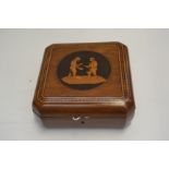 A late 19th Century olive wood casket, inlaid central figure scene to the cover, parquetry border