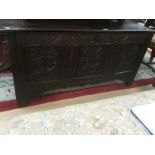 Late 17th Century oak coffer, heavily carved to front, possibly later