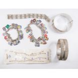 A collection of silver jewellery to include two silver bangles, two silver and enamel charm