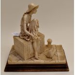 An Italian figurine of a girl on a packing case, dockside, in alabaster resin, first half of 20th