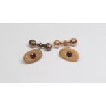 A pair of 9ct gold and garnet set cufflinks, oval with chain and bar components, inscribed J.H