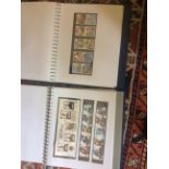 Four blue ring binder stamp albums (one empty) containing mint GB issues and early World stamps (4)