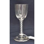 An 18th century wine glass, circa 1750, the round funnel bowl supported on a douple strand opaque