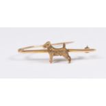 A 9ct gold bar brooch depicting a  'terrier', length approx 50mm,  total gross weight approx 5.5gms