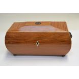 A Regency satinwood tea caddy, of bombe sarcophagus form, boxwood strung, triple division