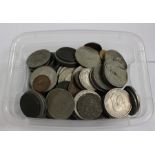 A box of assorted UK coins and tokens.