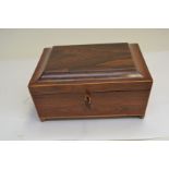 A Regency rosewood work box of sarcophagus from, boxwood strung, brass side handles, brass ball feet