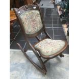 An Early 20th century oak childs rocking chair.
